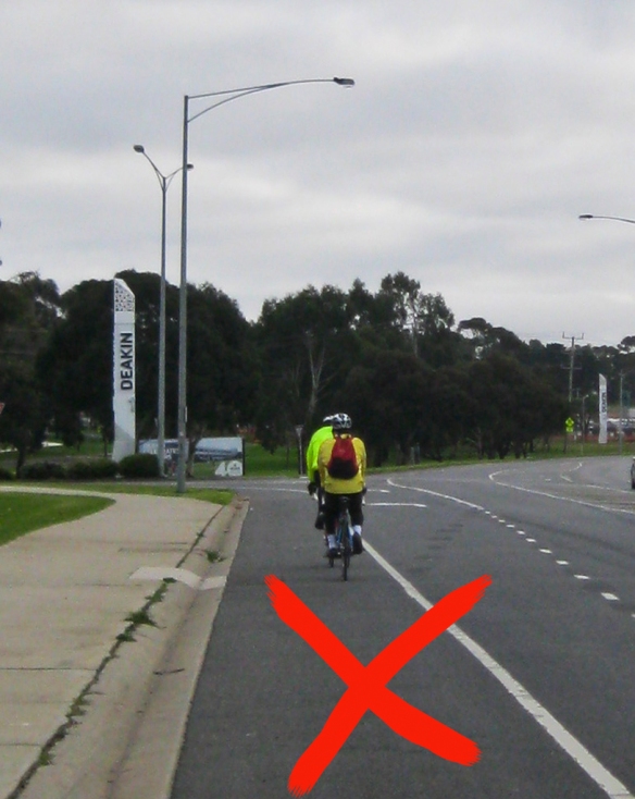 Lower Deakin entrance. Bike lane is to left of turn left lane. Cyclists must cross this fast moving traffic lane to go straight ahead. 